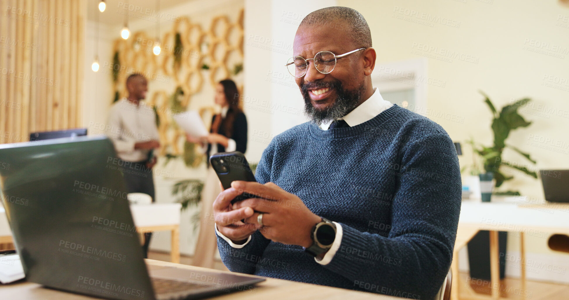 Buy stock photo Phone, creative and business man in office for email, notification or magazine editor typing review. Startup, mobile and happy mature manager online, reading article and check publication on laptop