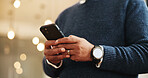 Person, hands and typing with phone for communication, social media or online chatting at hotel. Closeup, customer or user with mobile smartphone for texting app, check in or network at luxury resort