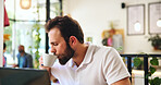 Cup, drink and laptop with man in cafe for remote worker, typing and planning. Feedback, business and client report with person and latte in coffee shop for freelancer, beverage and research