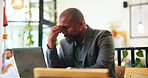 Headache, tired and man in coffee shop with stress, frustrated and burnout for remote work. Migraine, pain and person in cafe with fatigue or freelancer with bad news for financial crisis on laptop