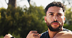 Man, fitness or stretching with arm at park for workout preparation, exercise or outdoor training. Serious, male person or thinking with warm up for flexibility, balance or active challenge in nature