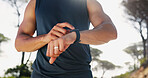 Man, hands and checking with smart watch for fitness tracking, performance or heart rate in nature. Closeup, active or male person with wristwatch for sport app, step counter or health and wellness