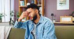 Stress, headache and man on sofa in home with regret, fear and frustration for relationship fail. Confused, migraine and male person relaxing in living room with trouble for grief, loss or breakup.