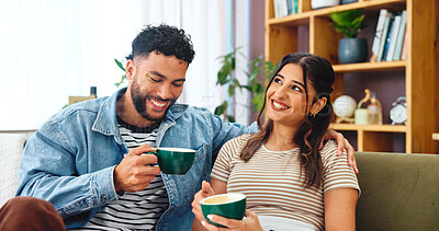 Buy stock photo Couple, coffee and laughing on sofa in home for bonding, funny conversation and relationship support. Living room, people or beverage with love, security and comic story for commitment, care or trust