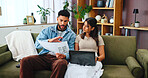 Documents, laptop and couple on sofa in home for bills, payment receipts and banking. Marriage, relationship and man and woman with paperwork for financial planning with taxes, insurance and budget