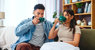 Buy stock photo Couple, relax and drinking coffee on sofa in home for bonding, relationship support or weekend break. Living room, people or beverage with love, security and comfortable for commitment, care or trust