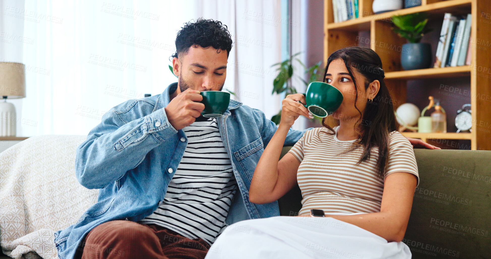Buy stock photo Couple, relax and drinking coffee on sofa in home for bonding, relationship support or weekend break. Living room, people or beverage with love, security and comfortable for commitment, care or trust