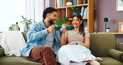 Buy stock photo Couple, coffee and talking on sofa in home for connection, relationship support or weekend break. Living room, people or beverage with love, security and comfortable for funny story, trust and care