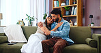 Home, hug and couple on couch, love and bonding together with weekend break in lounge. Embrace, comfort and man with woman, marriage and relax with romance, relationship and happiness with smile