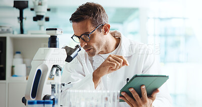 Buy stock photo Scientist, man and tablet by microscope in lab for medical research with container, review or vaccine development. Person, digital touchscreen and chemical analysis with pharmaceutical drugs on app