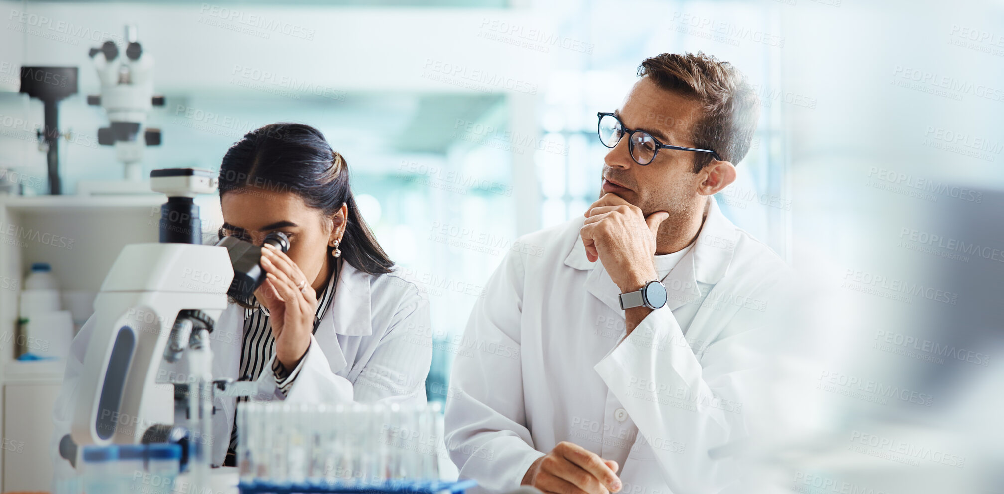 Buy stock photo Scientist, woman and man with microscope for chemistry, testing and medical research. Biotech, laboratory and assistant with mentor for pharmaceutical or pathology experiment for health breakthrough