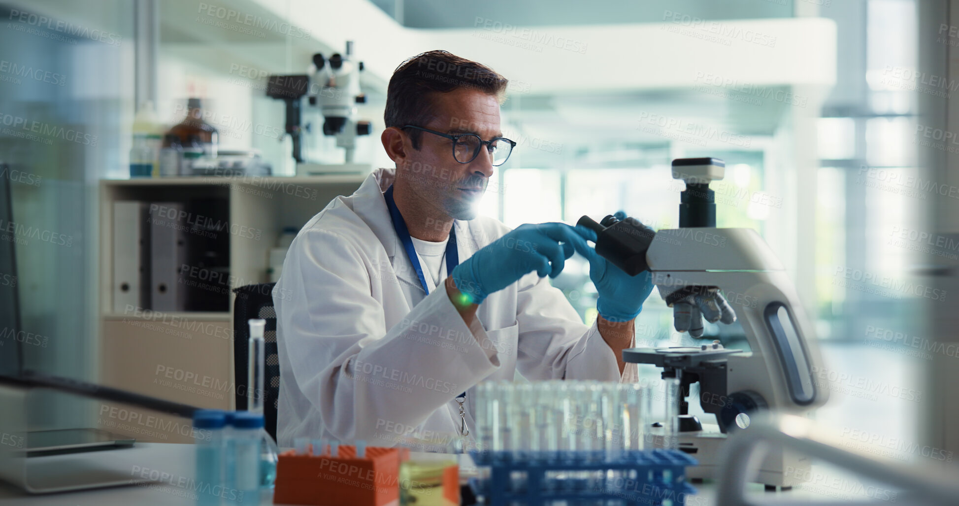 Buy stock photo Scientist, man and test by microscope in lab for medical research with container, study and vaccine development. Person, process and chemical analysis with pharma trial, drugs and lens for sample