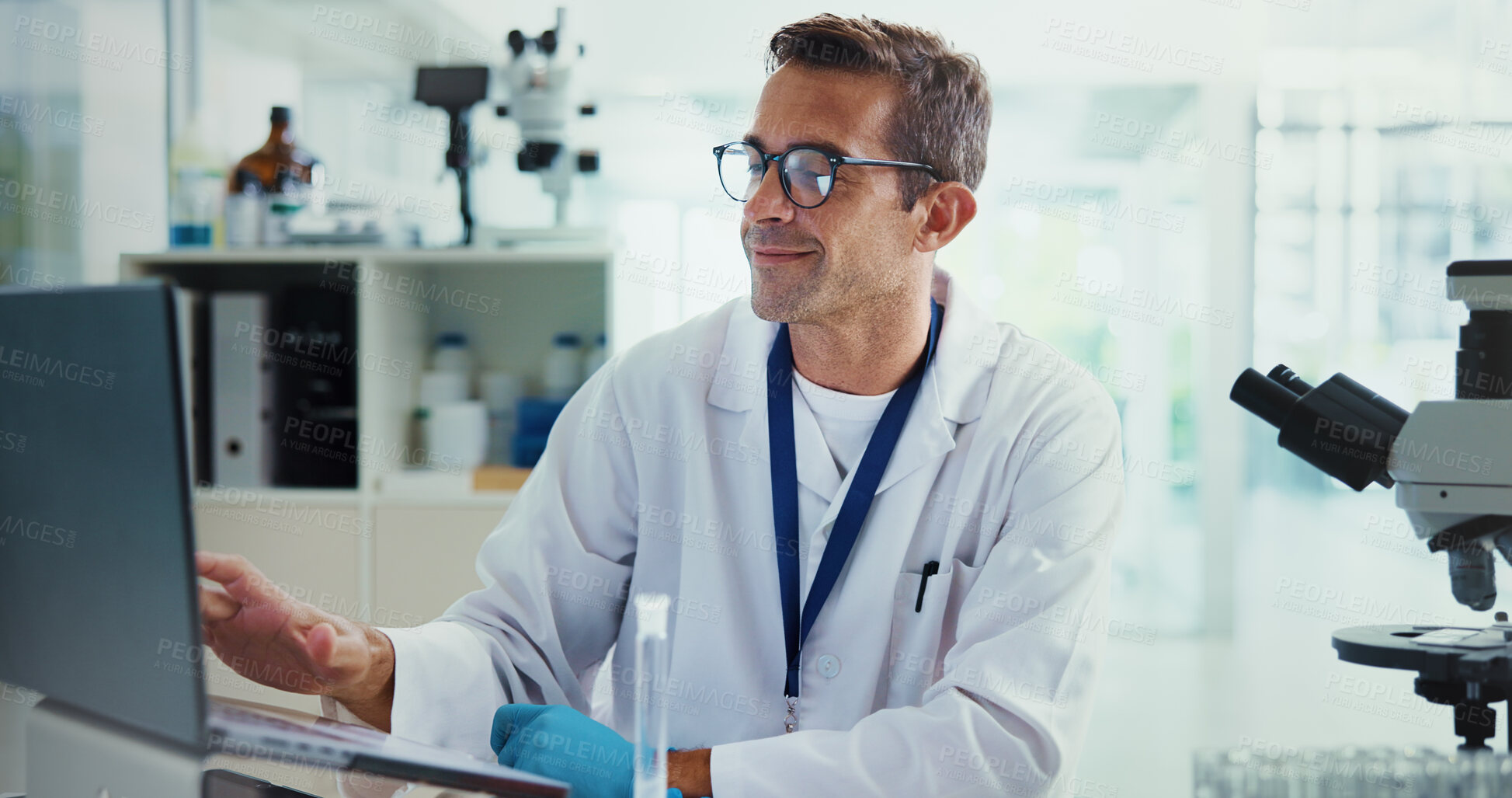 Buy stock photo Scientist, man and typing with laptop in lab for medical research with results, smile and vaccine development. Person, happy and computer for test, notification and feedback for pharmaceutical trial