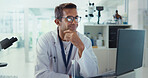 Scientist, man and happy by laptop in lab for medical research with reading, review and vaccine development. Person, smile and computer for test, notification and results for pharmaceutical trial