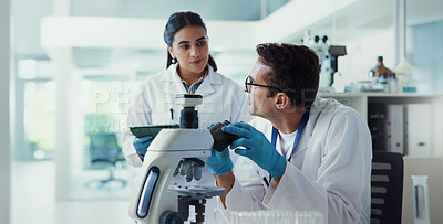 Buy stock photo Scientist, woman and man with microscope for pathology, testing and medical research. Chemistry, laboratory and assistant with tablet report for pharmaceutical or biotech experiment for breakthrough