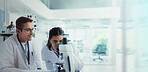 Scientist, woman and man with microscope for testing, advice and medical research. Pathology, laboratory and assistant with mentor report for pharmaceutical or biotech experiment for breakthrough