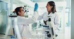 Scientist, woman and man and high five for chemistry testing, microscope and medical research. Pathology, laboratory and assistant with success for discovery or biotech experiment for breakthrough