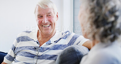Buy stock photo Laughing, senior couple and bonding in home, smile and romance for relationship in living room. House, old man and woman in retirement, comfortable and elderly people in lounge, talking or marriage