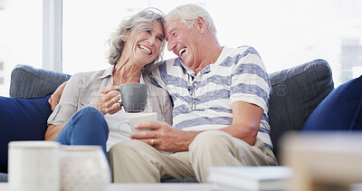 Buy stock photo Romance, relax and senior couple with coffee, home and bonding for relationship in living room. Forehead touch, old man and woman with tea, retirement and elderly people in lounge, laughing and love