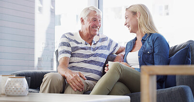 Buy stock photo Senior father, daughter and talk on sofa, happy and relax with coffee, love and reunion in living room at nursing home. People, story and laugh with man, woman and retirement with memory on couch