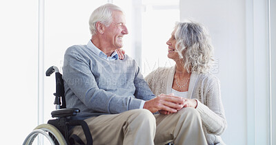 Buy stock photo Senior couple, holding hands and wheelchair in home, smile or care with help for injury in retirement. People, woman and support for elderly person with disability, rehabilitation or love in house