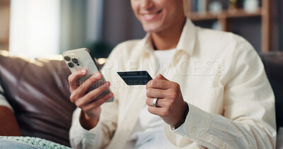 Buy stock photo Credit card, phone and hands of man on sofa for online shopping, internet banking or payment in home. Ecommerce, fintech and person on smartphone for website sale, purchase or discount in living room