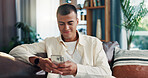 Home, sofa and man with smartphone for chat, online communication and text on dating website. House, male person and reading with mobile for application, message and scroll on social media in lounge