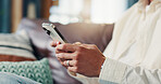 Phone, hands and person on sofa in home for social networking on mobile app for connection. Cellphone, communication and closeup texting for online dating with chat in living room at apartment.