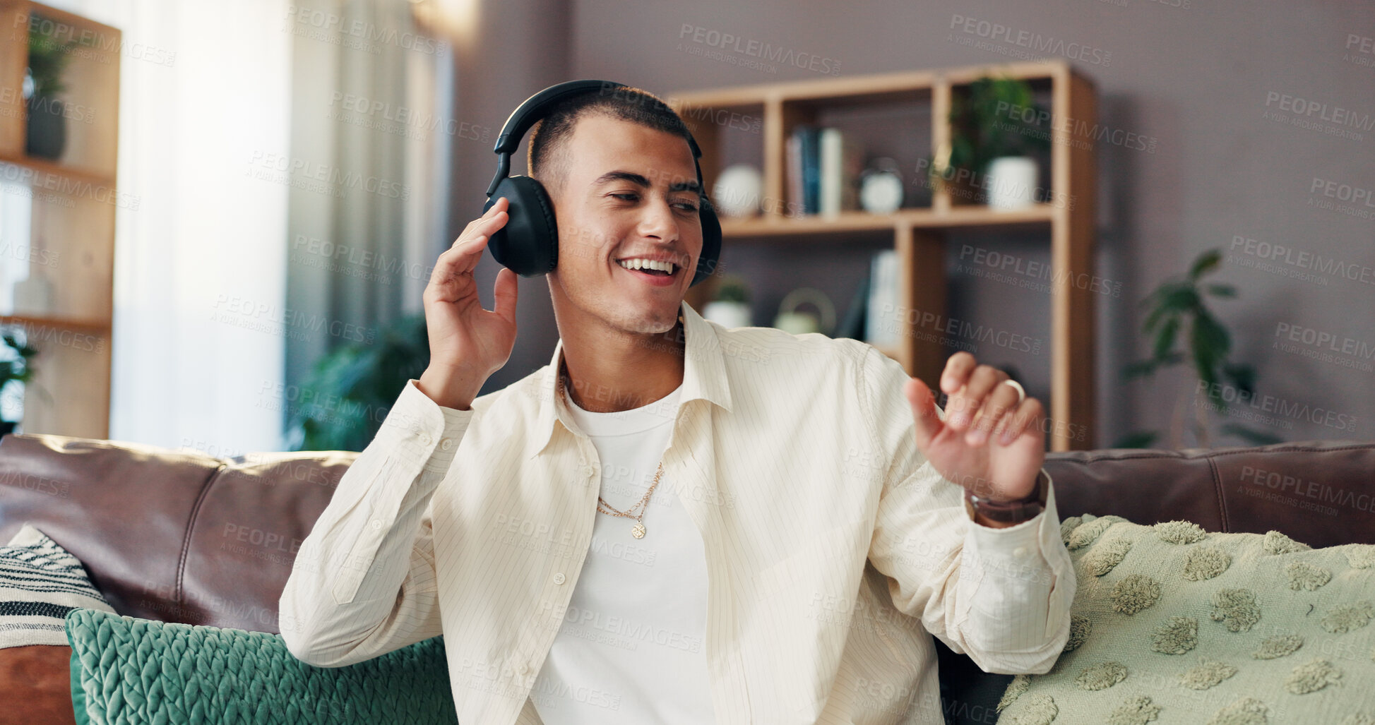 Buy stock photo Man, happy and dancing with headphones on sofa for music, sound and streaming subscription in living room. Person, smile and excited in lounge for memory, audio and listening on couch at apartment