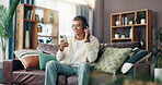 Man, smile and phone with headphones on sofa for music, social media and streaming subscription in living room. Person, happy and texting with smartphone, mobile app or listen on couch at apartment