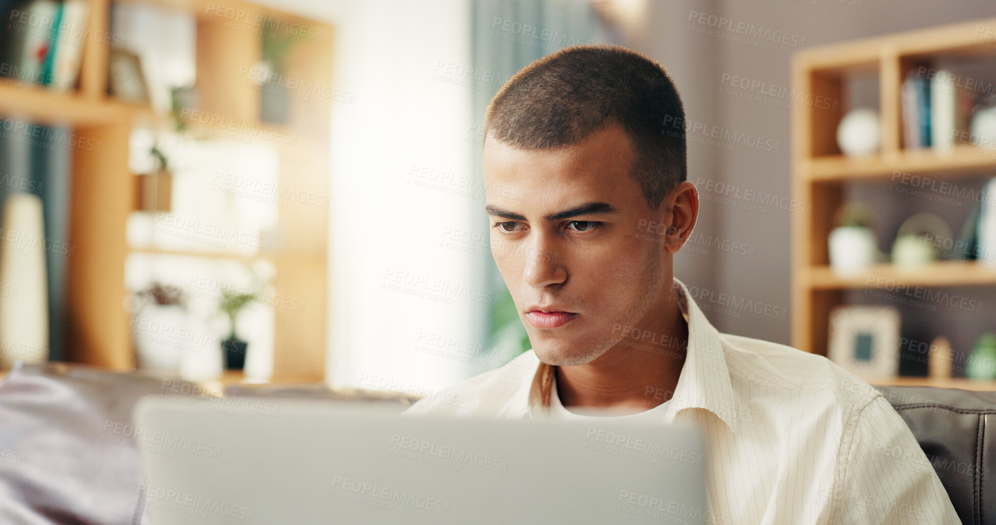 Buy stock photo Reading, student and man on sofa with laptop for online research, studying and elearning for college. Remote work, school and person on computer for project, assignment and education for university