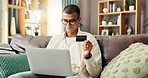 Credit card, laptop and man on sofa for online shopping, internet banking and payment in home. Ecommerce, fintech and person on computer for website sale, purchase and discount in living room