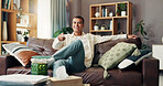Man, watching tv and happy on sofa, remote or choice for show, film or sports in living room at apartment. Person, smile and streaming subscription with movies, relax and laughing on couch in home