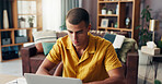 Man, creative and home with laptop for design, email or communication in remote work. Male person, freelancer or web designer typing with computer for software update, browsing or network at house