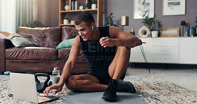 Buy stock photo Man, laptop and earphones for exercise on floor, online course or smile with typing for routine in home. Person, computer and virtual class for fitness, workout or training with break in living room