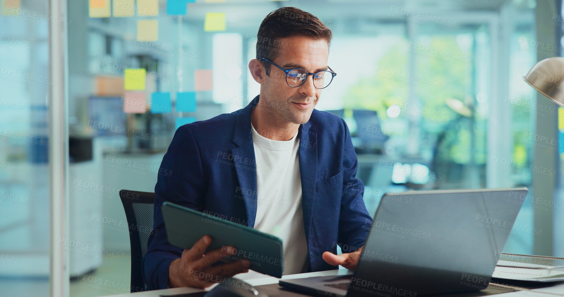 Buy stock photo Office, businessman and tablet with laptop for reading, typing article and research for news story. Career, male person and journalist from creative agency with digital, editing and website for blog