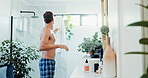 Man, shower and hygiene with towel in bathroom for grooming or morning routine at home. Male person, fabric or body care with equipment, cloth or preparation for skin treatment or drying at house