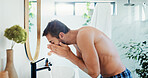 Man, washing or face with water in bathroom for skincare, disinfection or hygiene at home. Male person, rinse and facial treatment with hydration for morning routine, grooming or dermatology at house