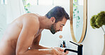 Man, face wash and mirror with tap in bathroom for skincare hygiene or cleaning at home. Male person, water and facial treatment with faucet for morning routine, grooming or dermatology at house