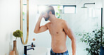 Man, mirror and hair care for shower in bathroom of hairstyle, cleaning hygiene and grooming routine. Person, shirtless and reflection for beauty results, natural texture and scalp treatment at house