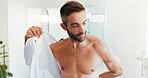 Hygiene, clothes and ready with man in bathroom for dressing, morning routine and grooming. Cleaning, corporate fashion and style with person and shirt at home for start, professional and confidence