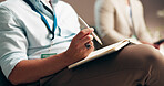Business person, hands and writing with notebook in seminar for learning, education or notes of meeting. Closeup, employee or diary with pen or plan for report, presentation or discussion at workshop