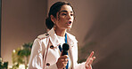 Woman, presentation and talking at convention with microphone, speech and discussion at workshop. Person, public speaking and advocacy for staff wellness, stage and corporate seminar in auditorium