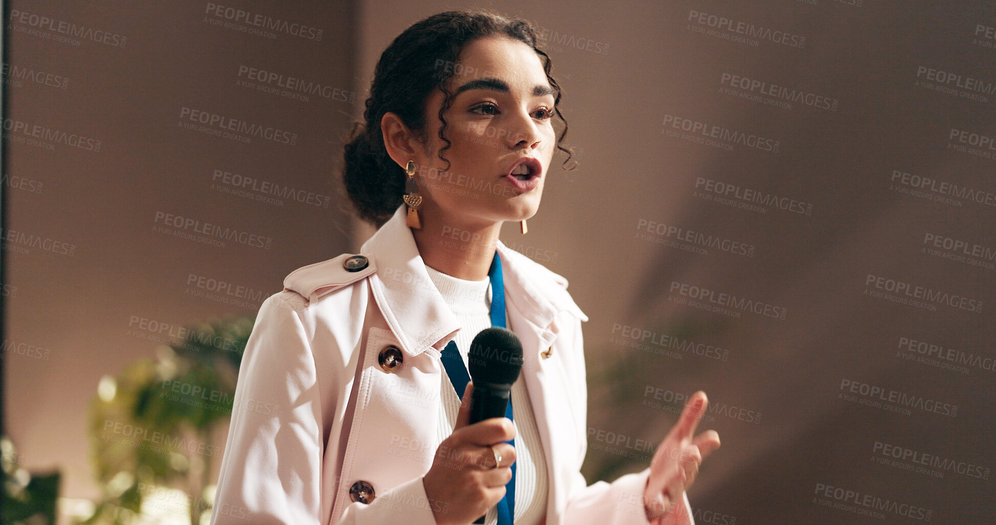 Buy stock photo Woman, presentation and talking at convention with microphone, speech and discussion at workshop. Person, public speaking and advocacy for staff wellness, stage and corporate seminar in auditorium