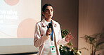 Business woman, workshop or speech for speaker in conference room for wellness training. Education, forum presentation and microphone with corporate coach on stage for public relations or development