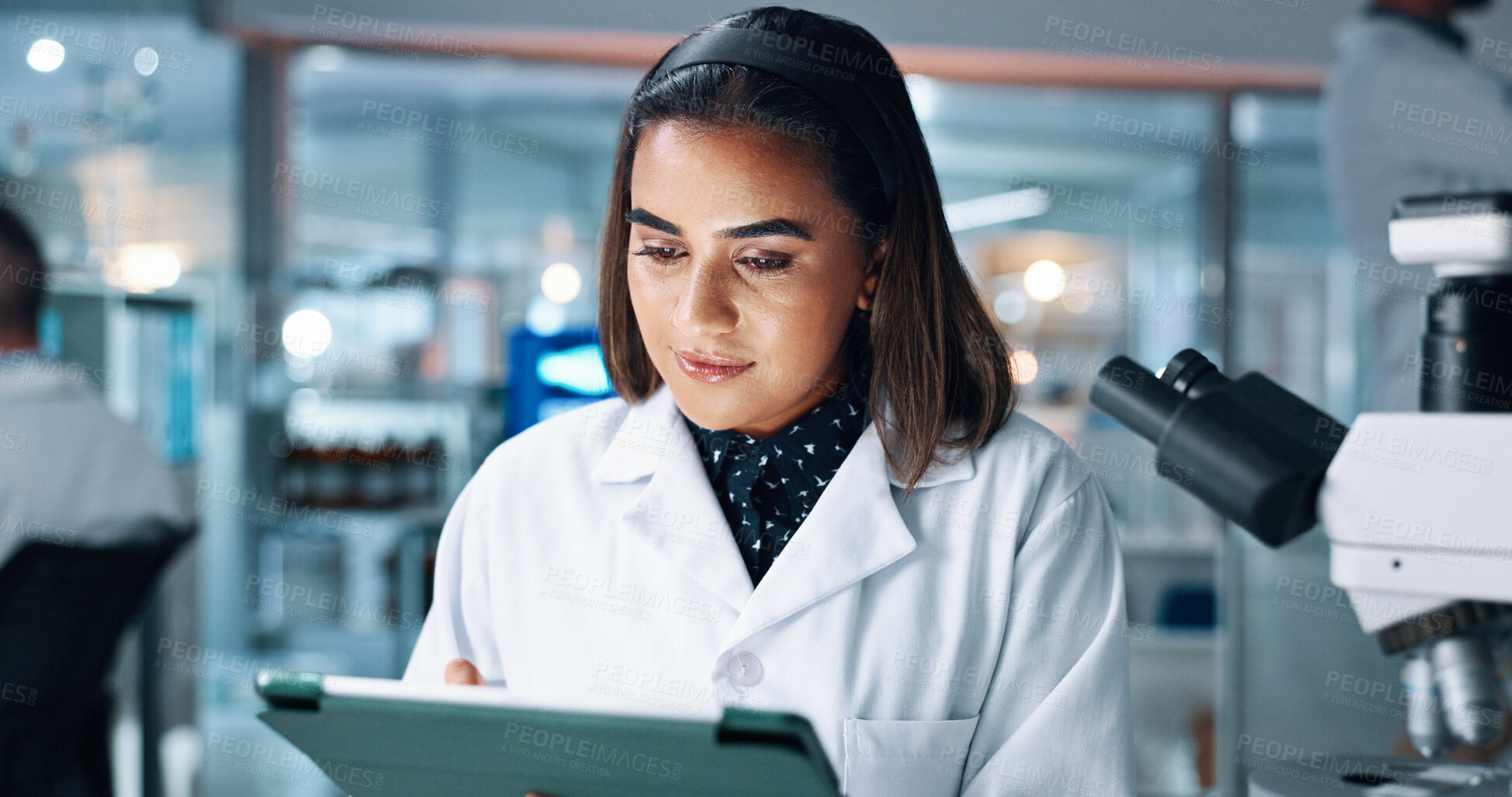 Buy stock photo Science, reading and tablet with woman in laboratory for research results, healthcare and report on study. Medical development, innovation and microscope with person for pharmacy and experiment
