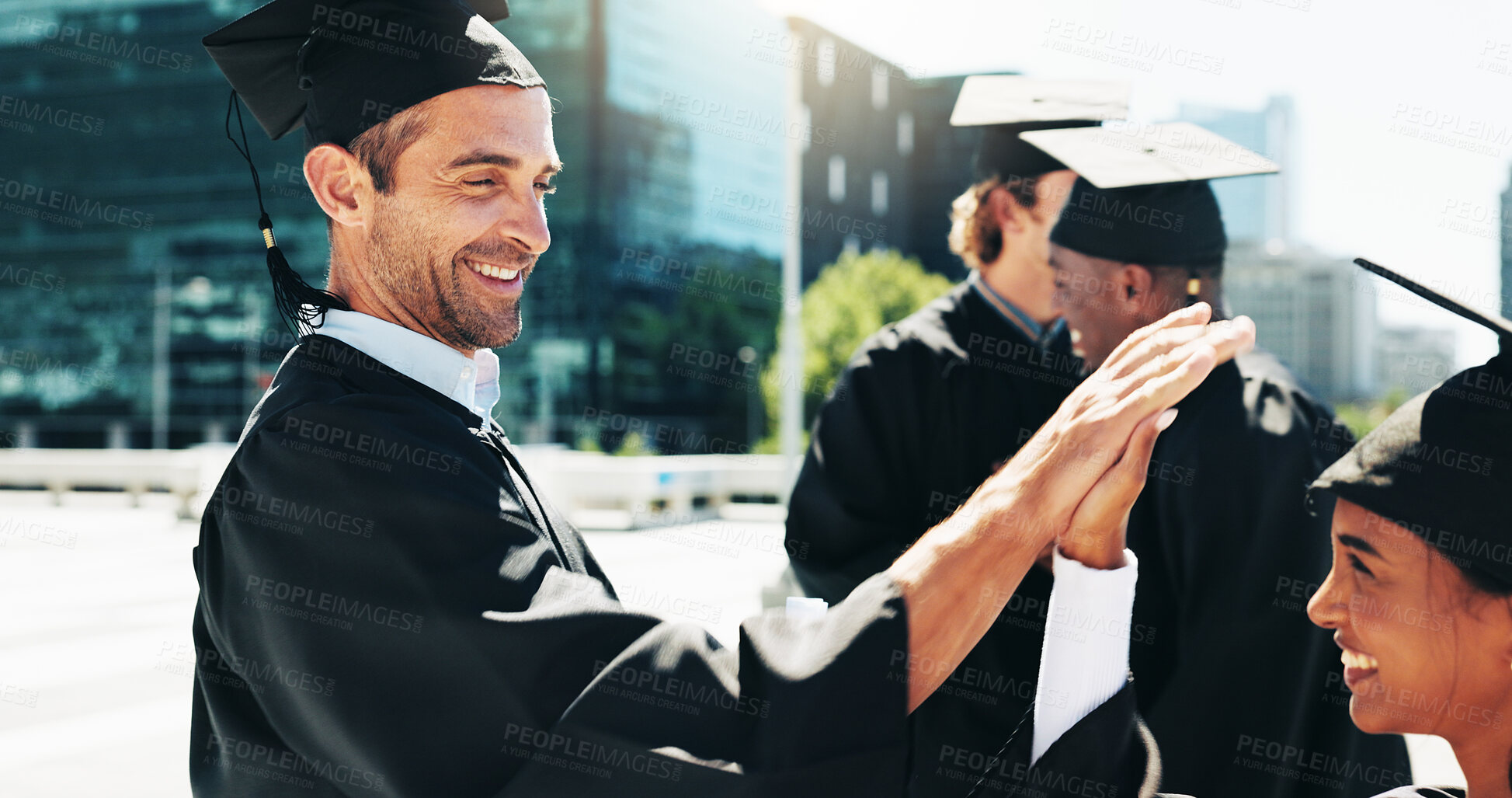 Buy stock photo Outdoor, graduation or high five with student friends in city for celebration or education event. Future, scholarship or success with happy college or university graduates in urban town for milestone