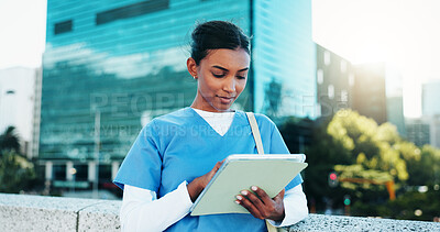 Buy stock photo Medical, student and woman with tablet outdoor for education, course or wellness email. Digital technology, city and healthcare nurse reading schedule, exam results or information at college campus
