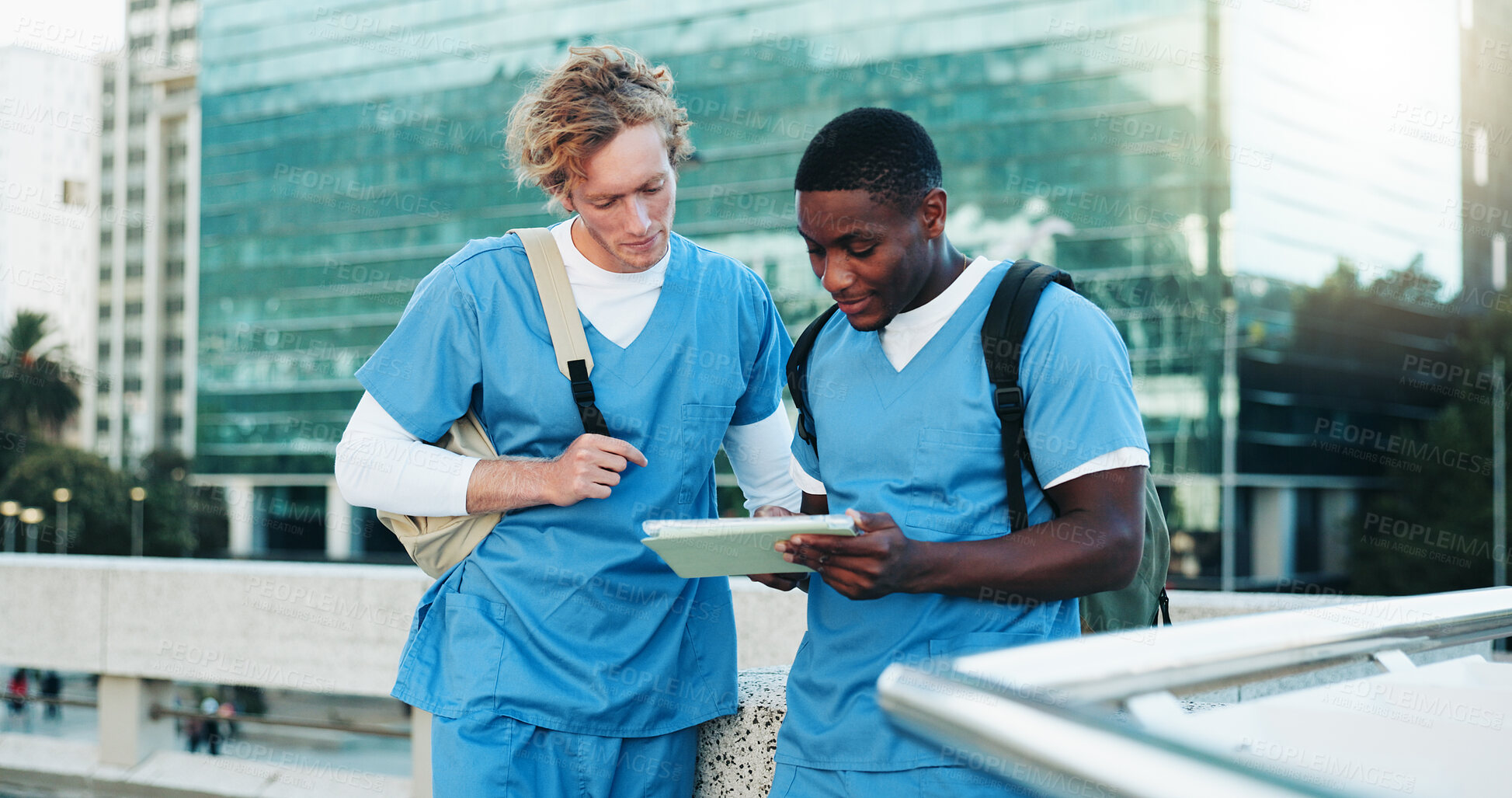 Buy stock photo Medical, students and men on tablet outdoor for education, help and discussion. Digital technology, city and healthcare nurses reading schedule, exam results and team learning for college on rooftop