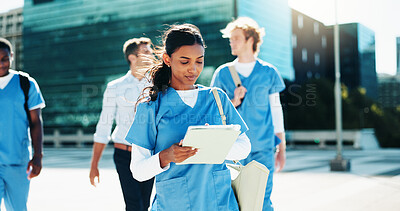 Buy stock photo Medical, nurse and woman with tablet in city for education, learning or wellness email. Digital technology, outdoor and healthcare student reading schedule, exam results or travel to college campus